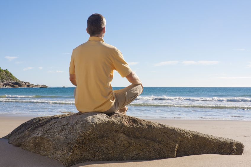man at beach pondering home remedies for hearing loss