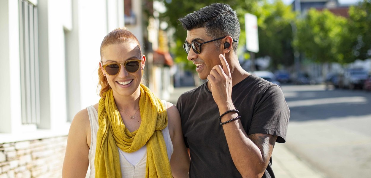 hear through earbuds in use on street