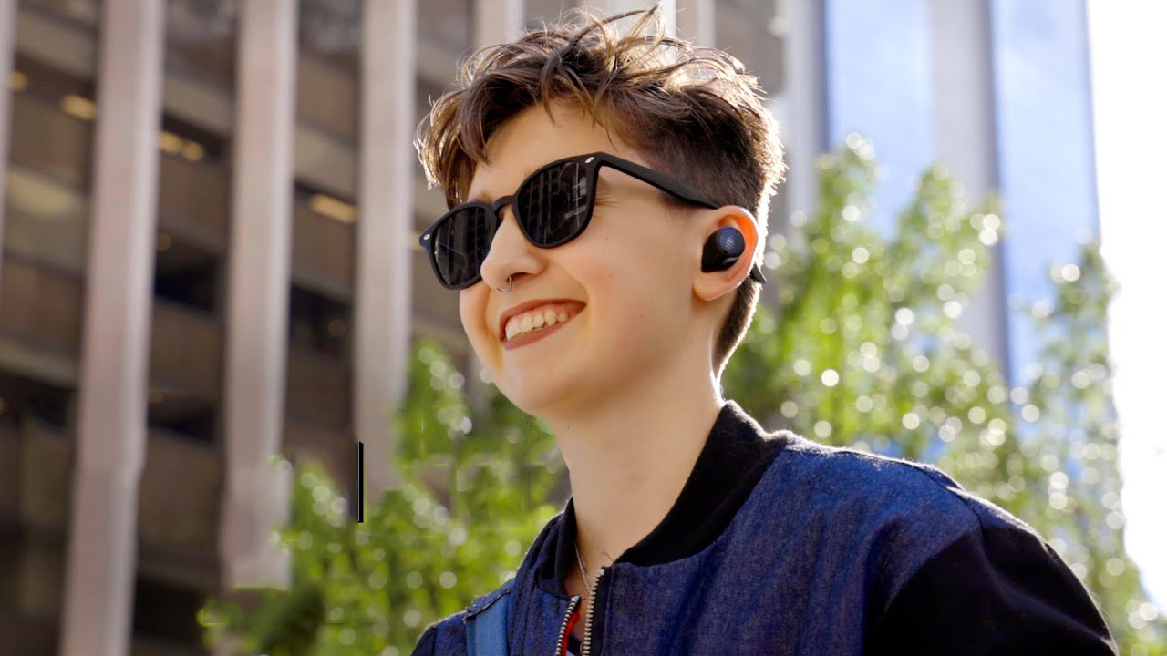 young woman with autism using IQbuds MAX earbuds