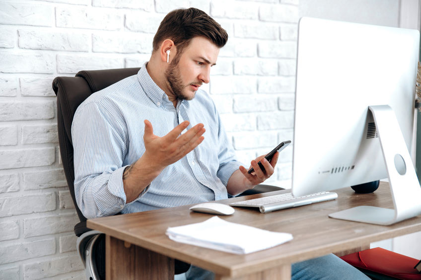 man frustrated while trying to use airpods as hearing aids