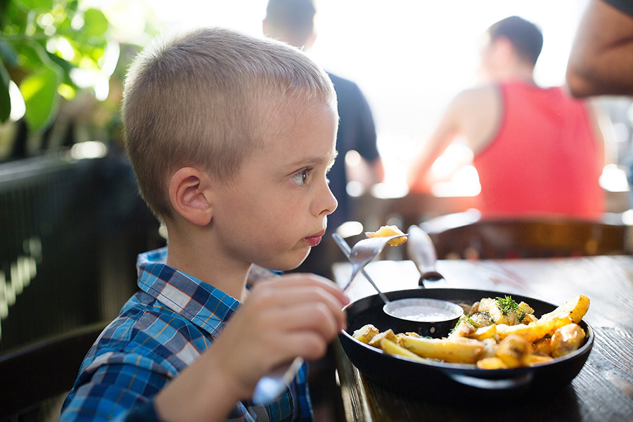 unhappy boy at dinner because of noise sensitivity anxiety