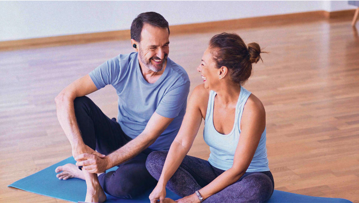 2 people doing yoga with IQbuds2 MAX