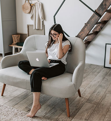 Lady smiling at laptop screen